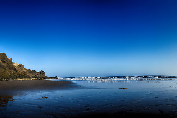 beach surrounded by rocks